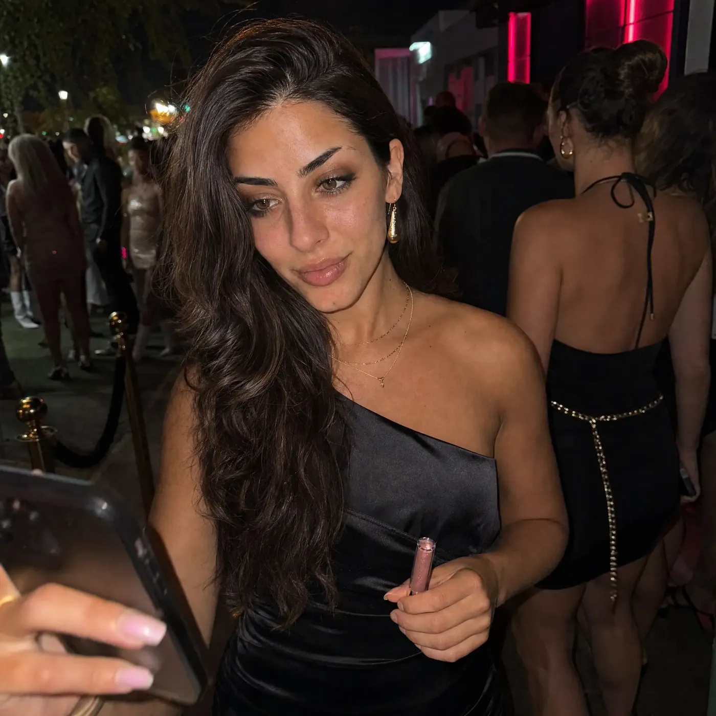 Waiting in line outside a club at night